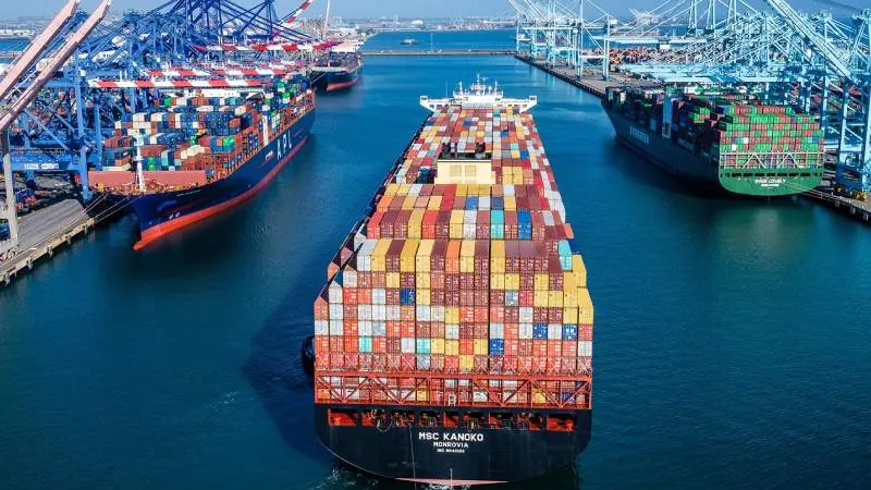 Container ships maneuvering in port, viewed from above, on a Europe-Chile route